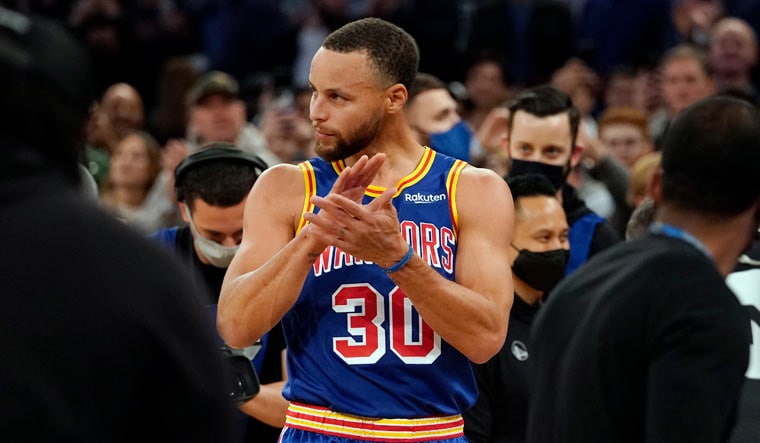 Golden State Warriors point guard Stephen Curry reacts after scoring his record-breaking 3-pointer | AP