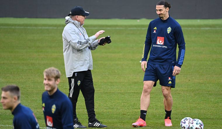 Sweden's forward Zlatan Ibrahimovic (R) talks with coach Janne Andersson during a training session in Stockholm | AFP