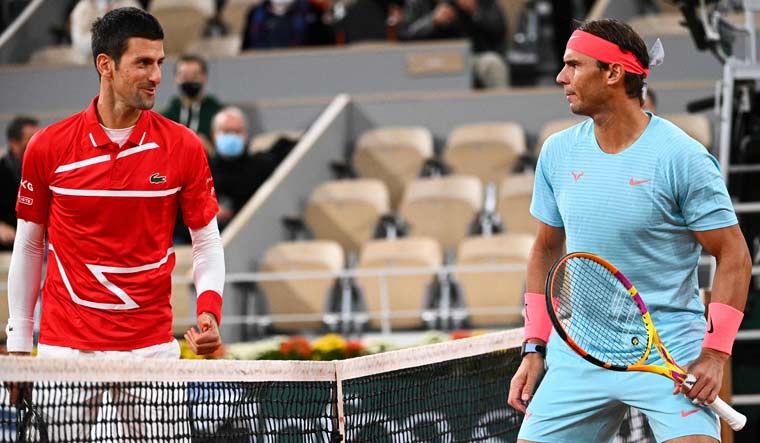 (File) Spain's Rafael Nadal (R) and Serbia's Novak Djokovic talk prior to their men's final match at the 2020 French Open in Paris | AFP