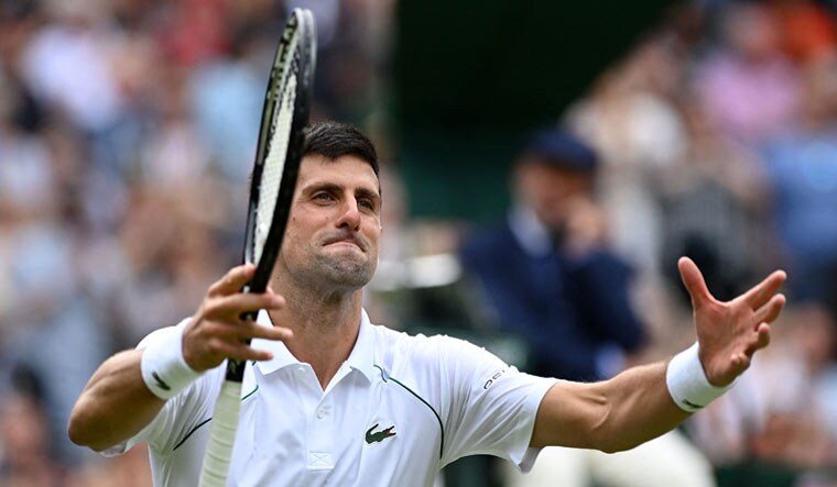 Novak Djokovic celebrates winning against Chile's Cristian Garin during their men's singles fourth round match on the seventh day of the 2021 Wimbledon Championships at The All England Tennis Club in Wimbledon | AFP