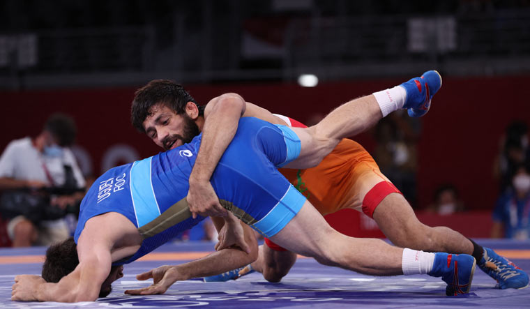 Russia's Zavur Uguev (blue) wrestles Ravi Kumar Dahiya in their men's freestyle 57kg wrestling final match during the Tokyo Olympics | AFP