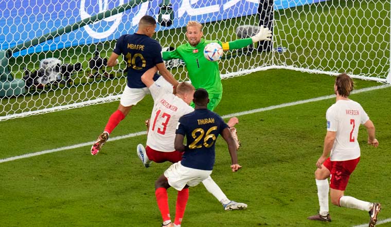 France's Kylian Mbappe, left, scores his sides second goal | AP