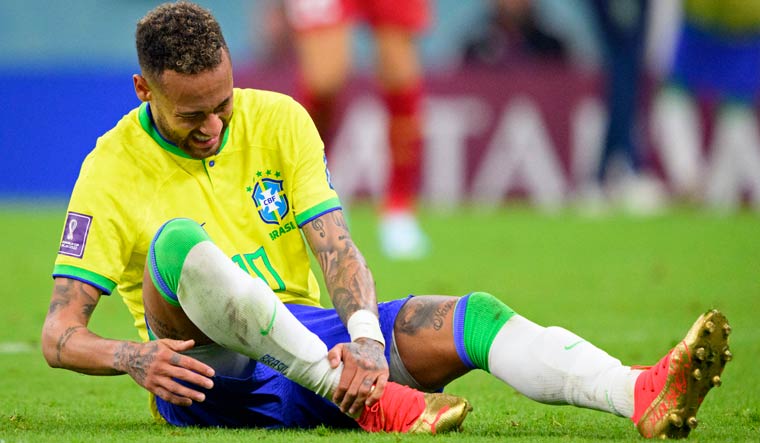 Neymar grabs his ankle after an injury during the World Cup group G match between Brazil and Serbia | AP