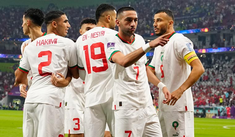 Morocco's Hakim Ziyech (7) celebrates with team mates after scoring his side's goal against Canada | AP