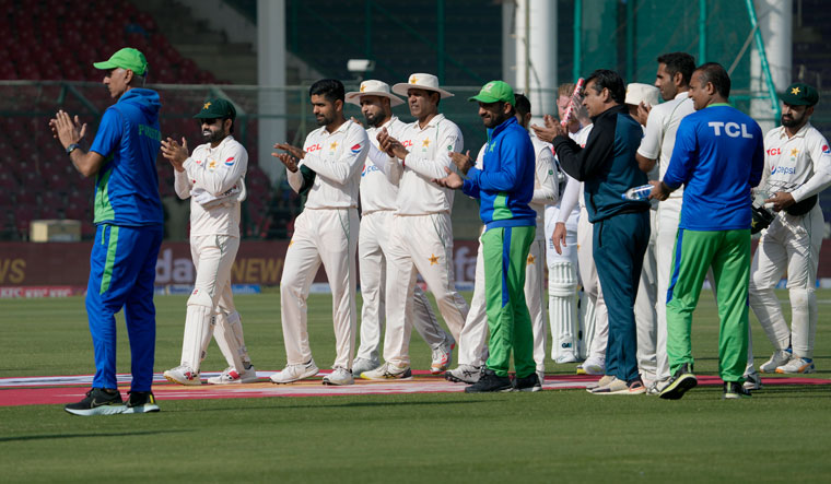 Pakistani players clap for teammates Azhar Ali, who played his last match, at the end of third Test cricket match between Pakistan and England, in Karachi on Tuesday | AP