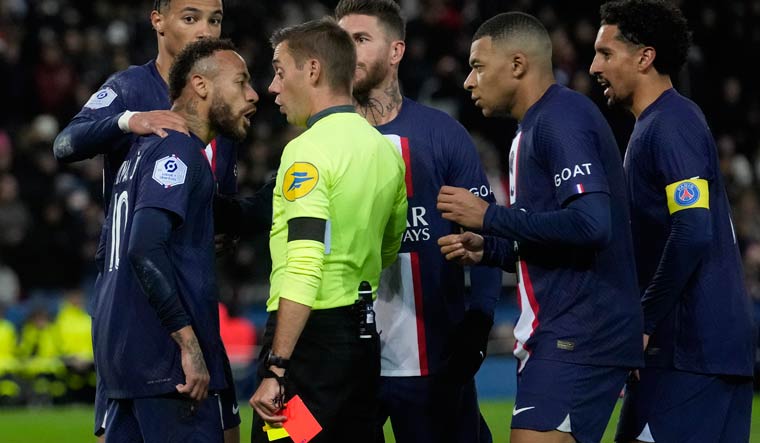 PSG's Neymar (front left) argues with referee Clement Turpin after being shown a red card during the Ligue 1 match against Strasbourg in Paris | AP 