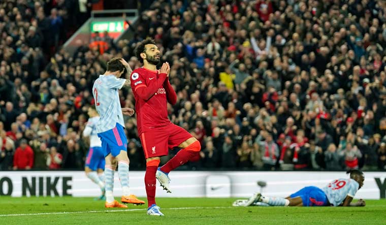 Liverpool's Mohamed Salah celebrates after scoring his side's fourth goal against Manchester United at Anfield | AP