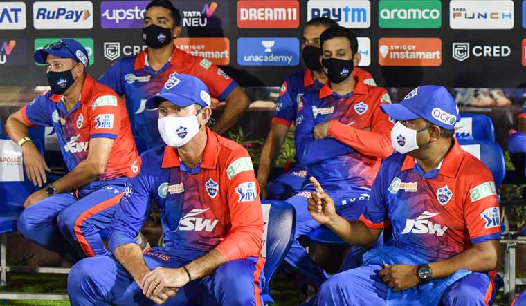 Delhi Capitals coaches Ricky Ponting, Ajit Agarkar and Praveen Amre and others sit at the team dugout, during the Indian Premier League 2022 match against Punjab Kings, at the Brabourne Stadium in Mumbai | PTI