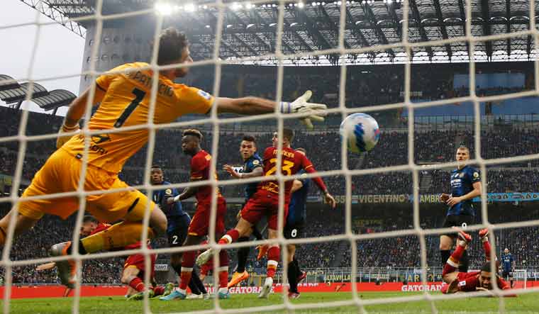 Inter Milan's Lautaro Martinez scores their third goal past AS Roma's Rui Patricio | Reuters
