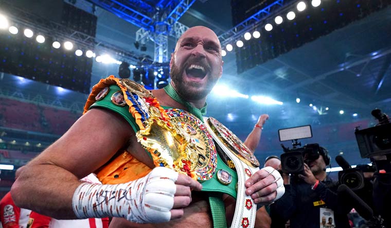 Britain's Tyson Fury celebrates after beating Britains Dillian Whyte to win their WBC heavyweight title boxing fight at Wembley Stadium in London, Saturday, April 23, 2022 | AP
