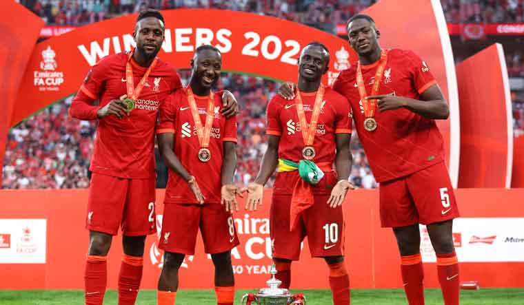 Liverpool's Sadio Mane, Divock Origi, Naby Keita and Ibrahima Konate celebrate with the trophy after winning the FA Cup final | AP