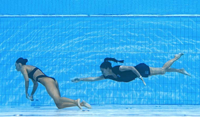 Anita Alvarez (L) sinks to the bottom of the pool after fainting during the women's solo free artistic swimming finals, during the Budapest 2022 World Aquatics Championships at the Alfred Hajos Swimming Complex in Budapest | AFP