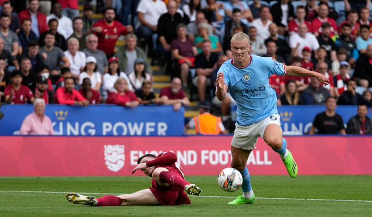 Manchester City's Erling Haaland, right, is challenged by Liverpool's Andrew Robertson during the FA Community Shield match in Leicester, England | AP