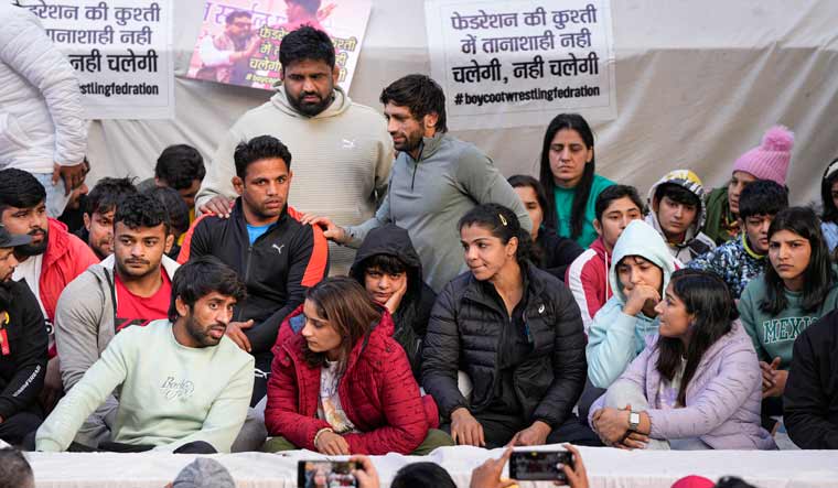 Wrestlers Vinesh Phogat, Sakshi Malik, Bajrang Punia and others during their ongoing protest against the Wrestling Federation of India (WFI), at Jantar Mantar in New Delhi | PTI