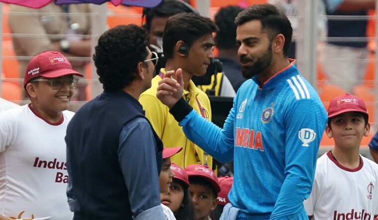 Virat Kohli with Sachin Tendulkar wearing a jersey with plain white stripes | Reuters