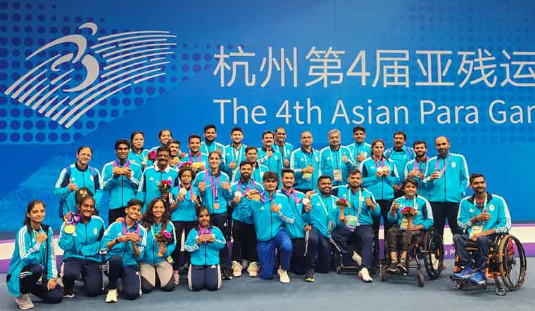 Para medallists with officials pose for group photos at the Asian Para Games, in Hangzhou | PTI