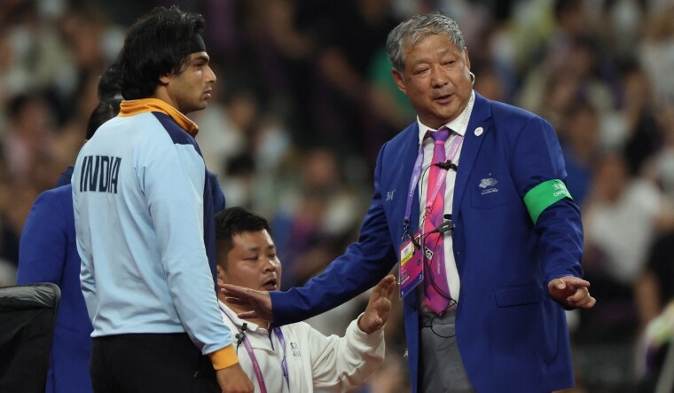 India's Neeraj Chopra speaks with a referee during the men's javelin throw final | Reuters