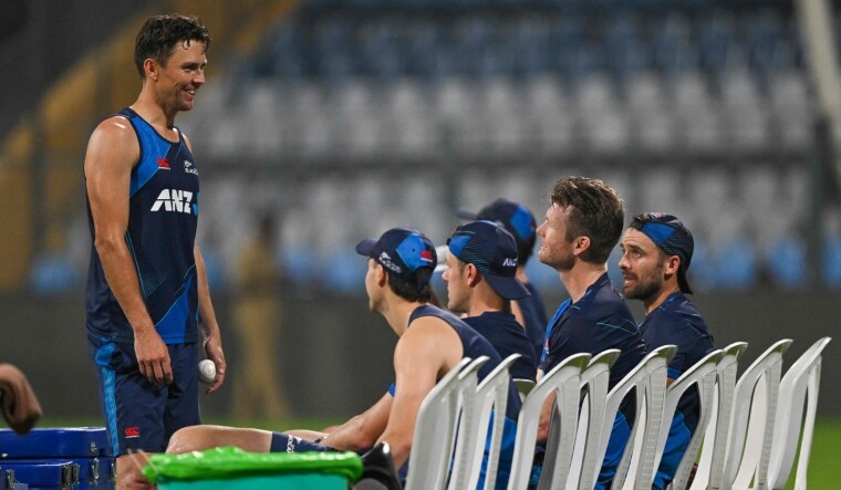New Zealand's Trent Boult (L) speaks with teammates during a practice session at the Wankhede Stadium | AFP