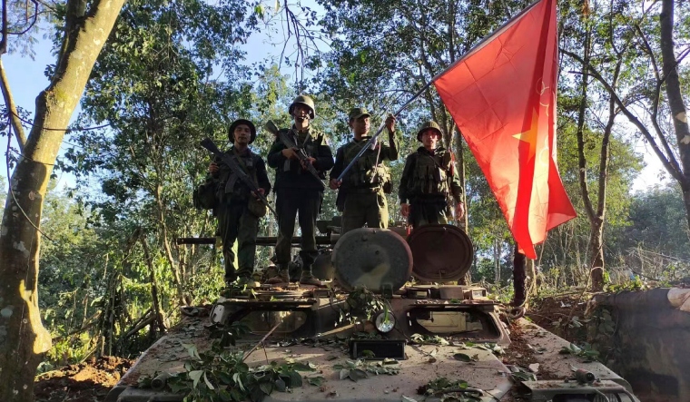 Members of the Myanmar National Democratic Alliance Army hold the group's flag | AP