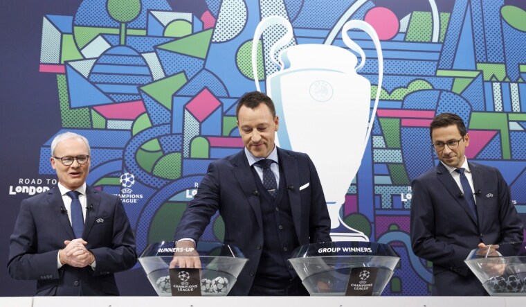 John Terry, between The UEFA Deputy General Secretary Giorgio Marchetti (L) and the UEFA head of club competitions Tobias Hedstuck, removes the balls containing the names of teams during the UEFA Champions League 2023/24 round of 16 draw. | AP