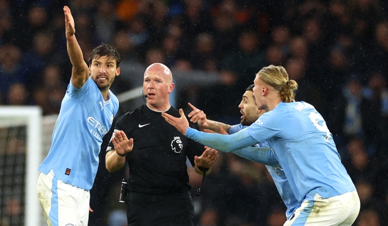 Manchester City's Erling Haaland with teammates remonstrate with referee Simon Hooper | Reuters