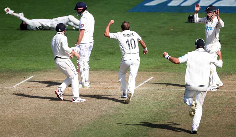 New Zealand's Neil Wagner (C) celebrates taking the final wicket of England's James Anderson (centre L) to win the second Test match, in Wellington | AFP