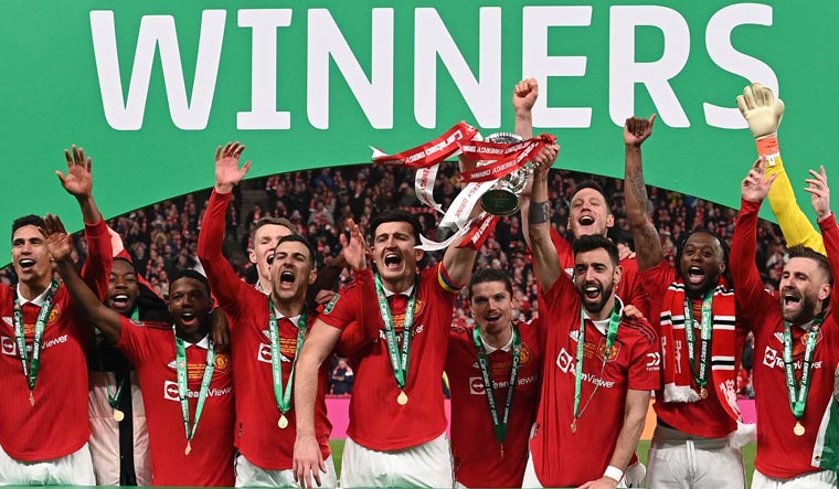 Manchester United's players celebrate with the English League Cup trophy at Wembley Stadium, London. United beat Newcastle 2-0 in the final | AFP