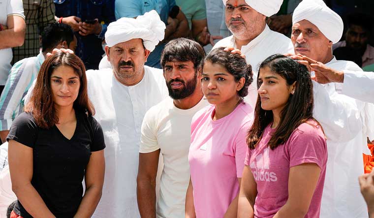 Farmer leader Naresh Tikait with wrestlers Bajrang Punia, Vinesh Phogat, Sakshi Malik and Sangita Phogat during their protest at Jantar Mantar in New Delhi | PTI