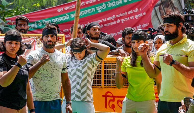 New Delhi: Wrestlers wear black bands during their ongoing protest against Wrestling Federation of India (WFI) chief Brij Bhushan Sharan Singh, at Jantar Mantar in New Delhi, Thursday, May 11, 2023. (PTI Photo/Kamal Singh) (PTI05_11_2023_000017A)