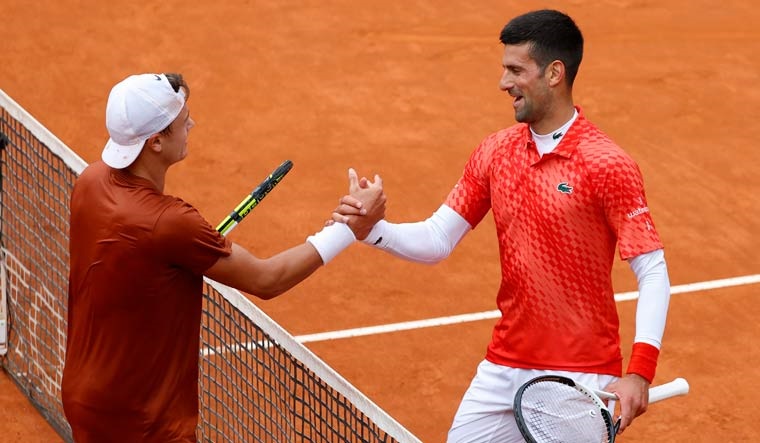 Denmark's Holger Rune shakes hands with Serbia's Novak Djokovic after winning his quarter final match | Reuters