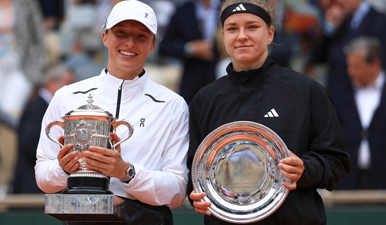 Poland's Iga Swiatek, left, celebrates winning the women's final match of the French Open tennis tournament against Karolina Muchova of the Czech Republic, right, in three sets, 6-2, 5-7, 6-4, at the Roland Garros stadium in Paris, Saturday, June 10, 2023. (AP Photo/Aurelien Morissard)