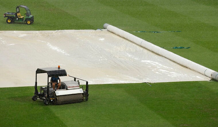 Cricket - Ashes - First Test - England v Australia - Edgbaston Cricket Ground, Birmingham, Britain - June 18, 2023General view as ground staff work on the field during a rain delay Action Images via Reuters/Andrew Couldridge