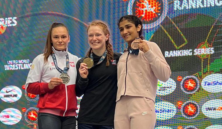 India's Sangeeta Phogat (R) poses for photographs after winning the bronze medal at the Budapest Ranking Series 2023 tournament, in Budapest, Hungary | PTI
