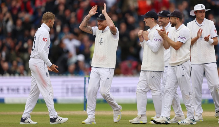 Cricket - Ashes - Fourth Test - England v Australia - Old Trafford Cricket Ground, Manchester, Britain - July 22, 2023 England's Joe Root celebrates with Ben Stokes after taking the wicket of Australia's Marnus Labuschagne, caught by Jonny Bairstow Action Images via Reuters/Lee Smith