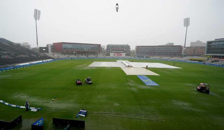 Rain covers are laid out on the pitch the fifth day of the fourth Ashes Test match between England and Australia at Old Trafford, Manchester | AP