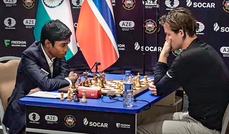 R. Praggnanandhaa and Magnus Carlsen during the second match of the Chess World Cup 2023 final, in Baku | PTI
