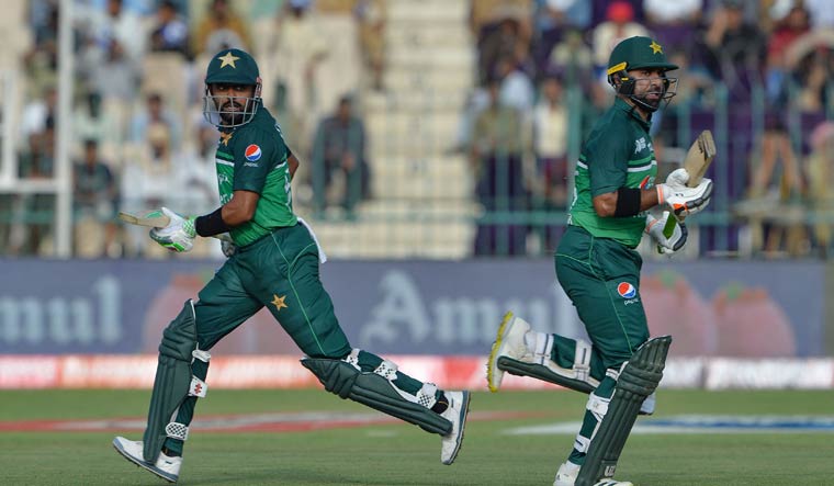 Pakistan's captain Babar Azam (L) and Iftikhar Ahmed run between the wickets | AFP