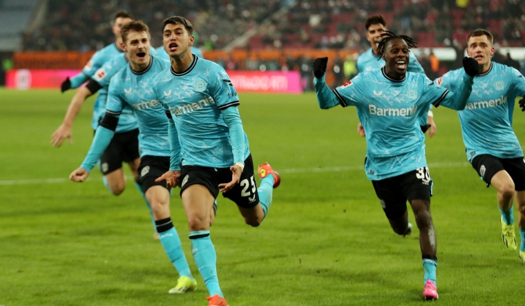 Bayer Leverkusen's Exequiel Palacios celebrates scoring with Jeremie Frimpong and others | Reuters