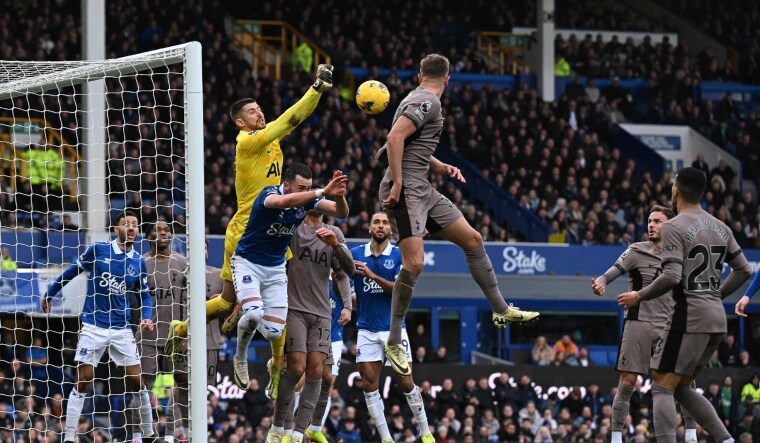 Tottenham Hotspur's goalkeeper Guglielmo Vicario (in yellow) saves a shot on goal during the English Premier League football match against Everton | AFP