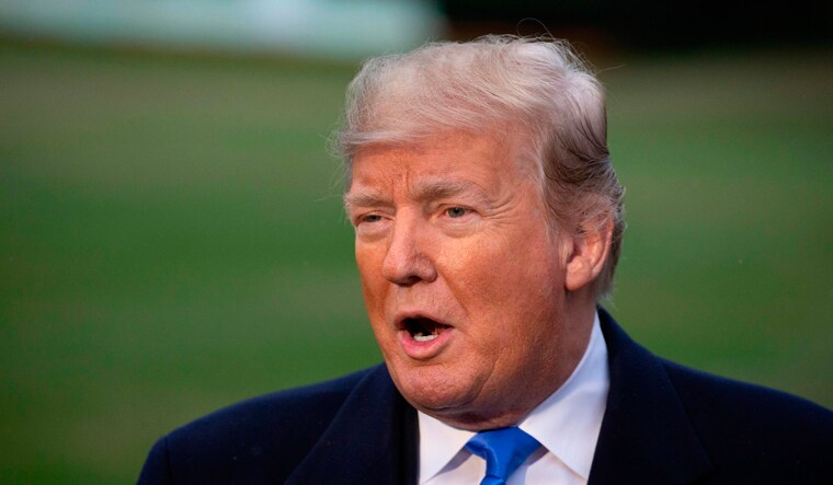 US President Donald Trump talks to reporters on the South Lawn of the White House prior to boarding Marine One in Washington, DC | AFP