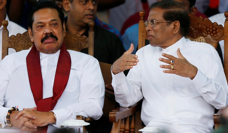 Prime Minister Mahinda Rajapaksa (left) and President Maithripala Sirisena talk at a rally in Colombo | Reuters