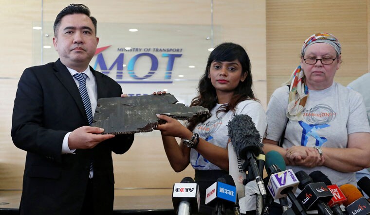 Grace Nathan, whose mother was onboard the missing Malaysia Airlines flight MH370, hands over a debris believed to belong to MH370 to Malaysia's Transport Minister Anthony Loke Siew Fook in Putrajaya, Malaysia November 30, 2018 | Reuters