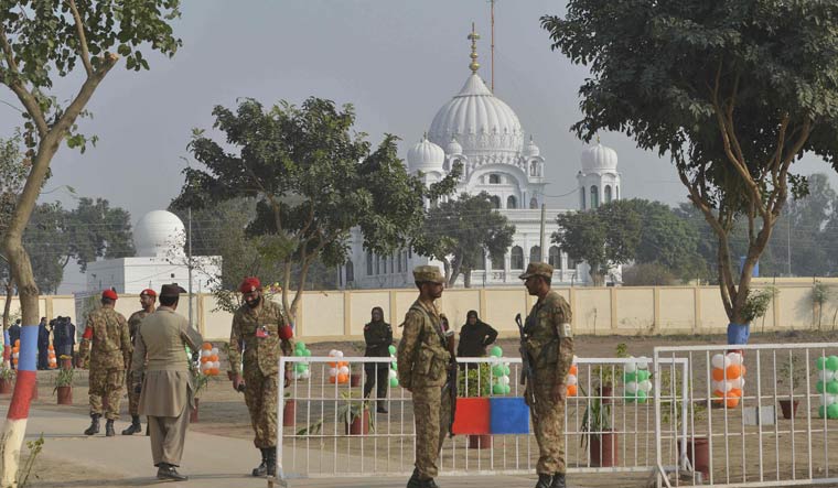 Pakistani army soldiers gather in front of Kartarpur Gurdwara Sahib during the groundbreaking ceremony for the Kartarpur Corridor in Kartarpur on November 28 | AFP