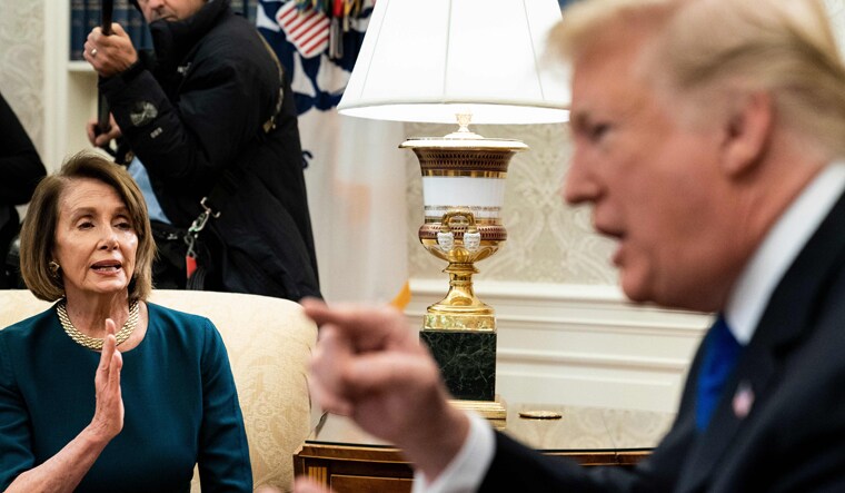 Presumptive Speaker, House Minority Leader Nancy Pelosi (D-CA) and US President Donald Trump argue while making statements to the press before a meeting at the White House on Tuesday in Washington, DC | AFP