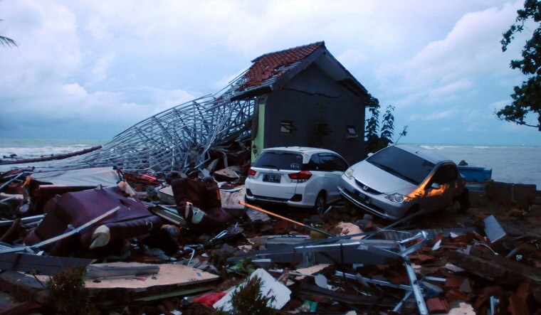 Debris from damaged buildings and cars are seen near the beach in Anyer, Serang, after being hit by the tsunami | AFP