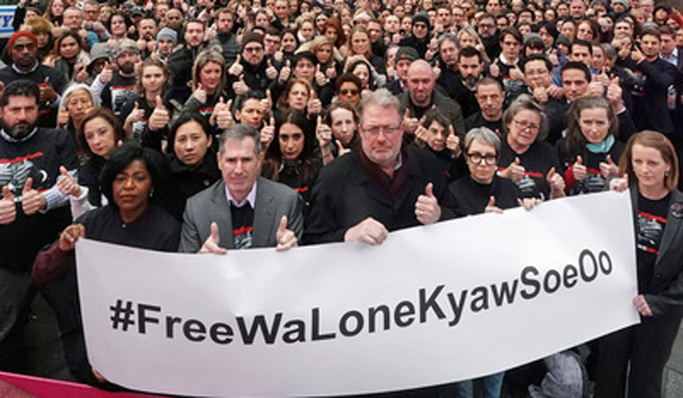 Reuters staff members pose for a photo in support of journalists incarcerated in Myanmar Wa Lone and Kyaw Soe Oo in Times Square | Reuters