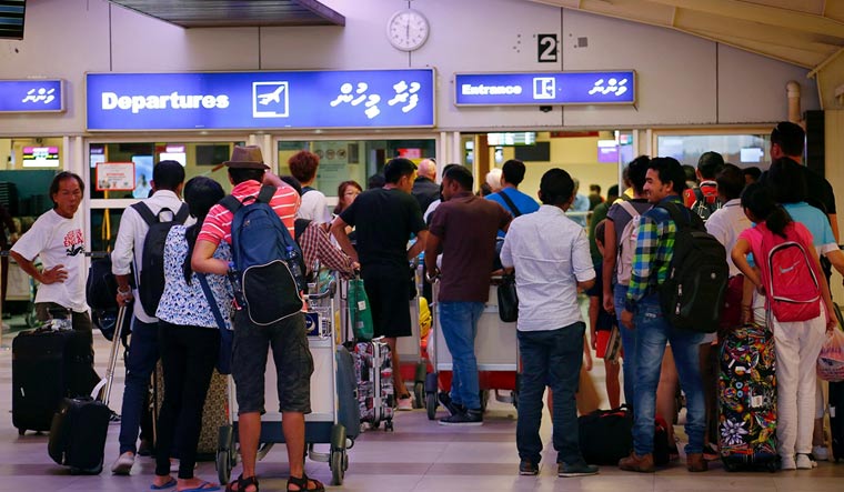 Tourists wait in the departures hall at Velana International Airport in Male | Reuters