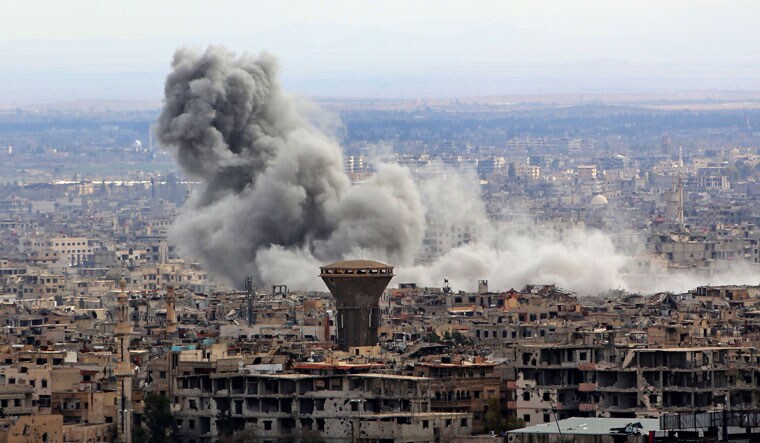 Smoke rising from the rebel-held enclave of Eastern Ghouta following fresh air strikes and rocket fire on February 27, 2018 | AFP