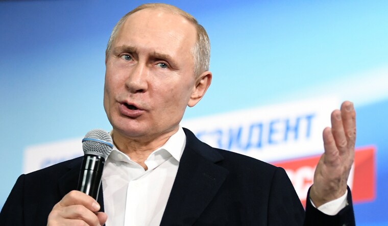 Russian President and Presidential candidate Vladimir Putin speaks during a meeting with supporters at his campaign headquarters in Moscow, Russia | Reuters