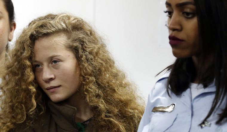 Palestinian Ahed Tamimi, 16-year-old prominent campaigner against Israel's occupation, appears at a military court at the Israeli-run Ofer prison in the West Bank village of Betunia | AFP
